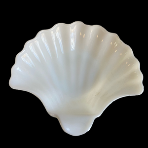 White milk glass shell dish with scalloped edges in ribbed seashell shape